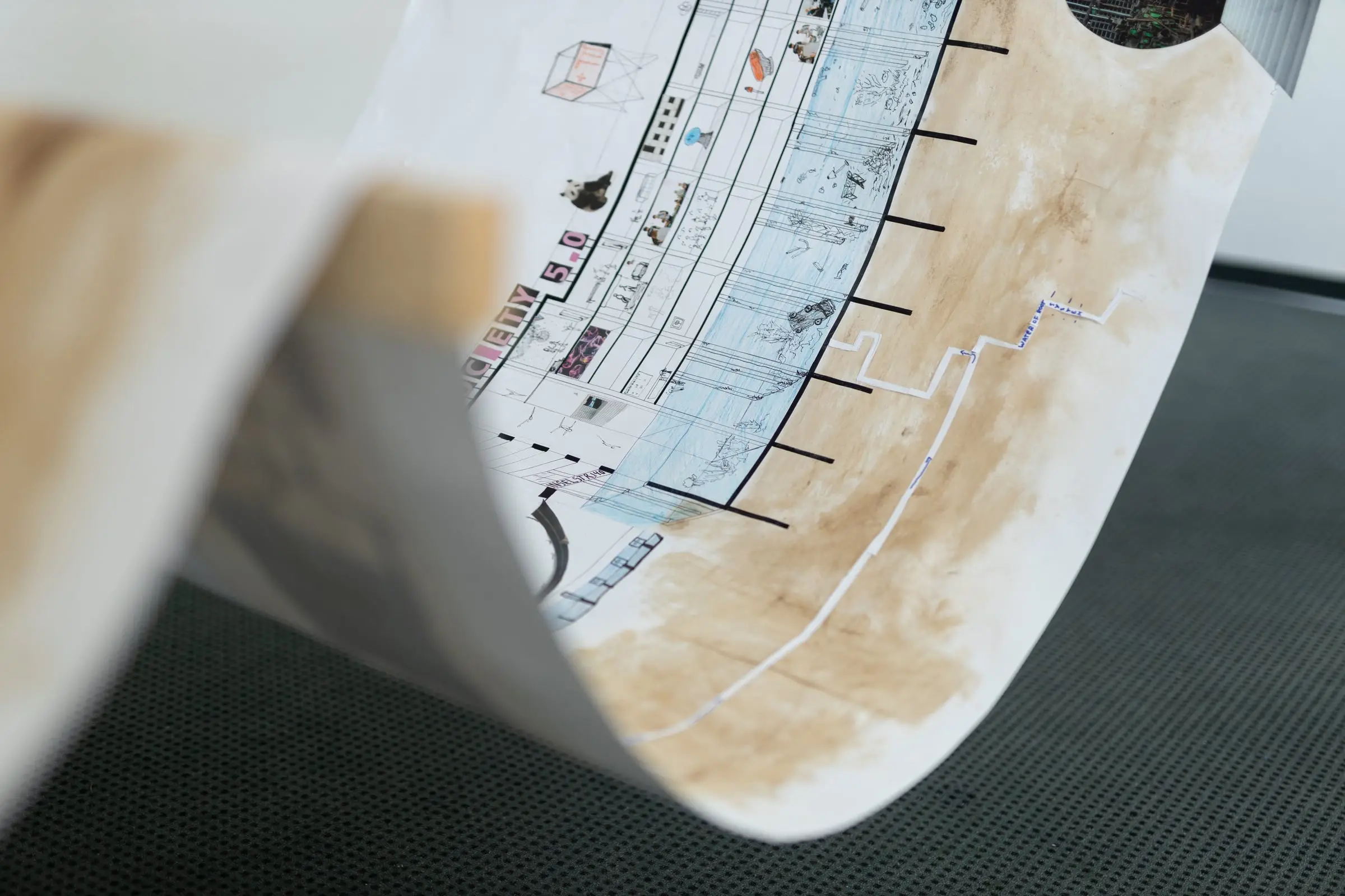 Close view of the curling paper section, drawn river levels and stained paper