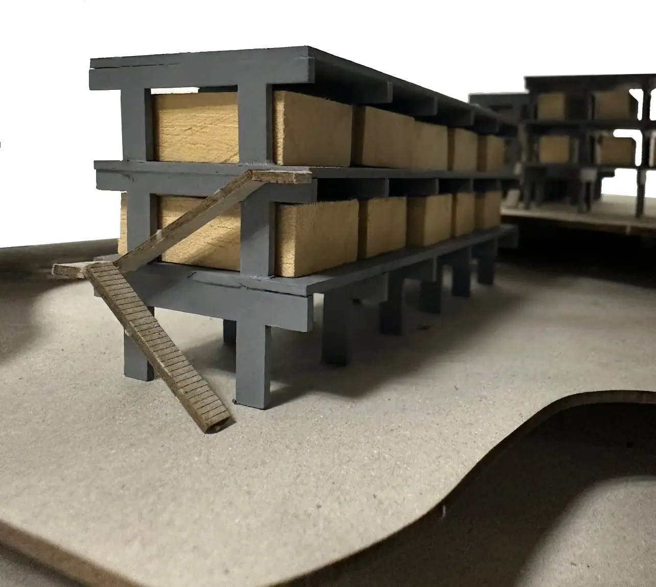 Close view of the model: the grey frame on columns with timber boxes and a stair